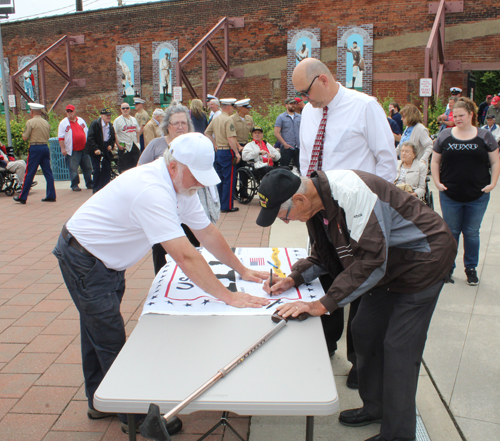 World War II Veterans signing the banner