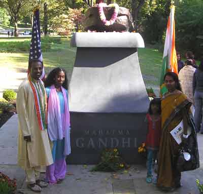 People posing by the new Mahatma Gandhi statue