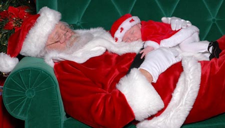 Santa Claus asleep with a baby