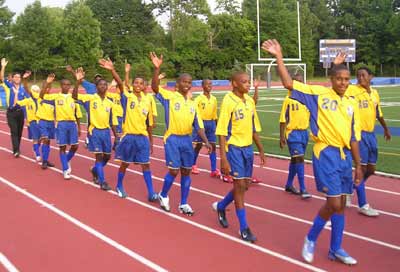 Soccer players from Barbados parade into Don Shula stadium