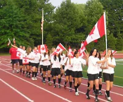 Soccer players from Canada parade into Don Shula stadium for Opening Ceremonies