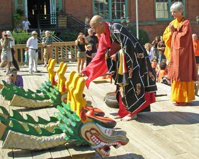 Buddhist Monk blessing the dragon boat dragon heads