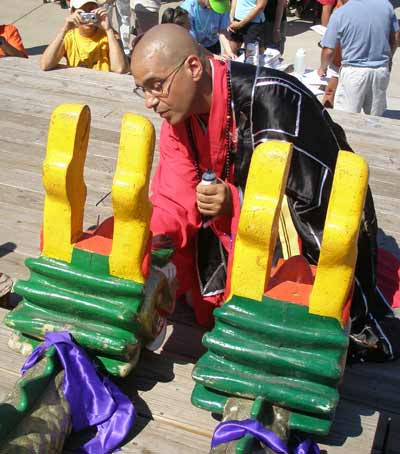 Buddhist Monk paints in the eyes of the dragon heads