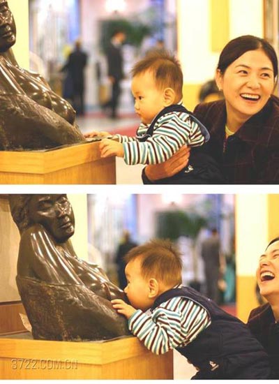 Baby nursing at statue
