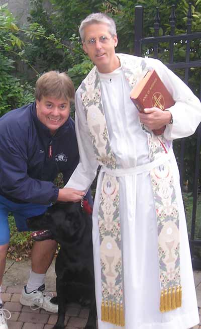 Dan Hanson with Hogan and Father Chris Weber