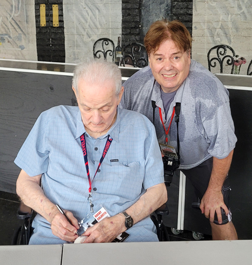 Dan Hanson watching Rocky Colavito sign his baseball
