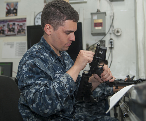 Aviation Ordnanceman Airman Curt Wozniak, from Cleveland, Ohio, cleans an M4 rifle in the ship's armory aboard aircraft carrier USS Carl Vinson (CVN 70). Carl Vinson is pierside at Naval Air Station North Island. (U.S. Navy photo by Mass Communication Specialist 3rd Class Scott Fenaroli/Released)