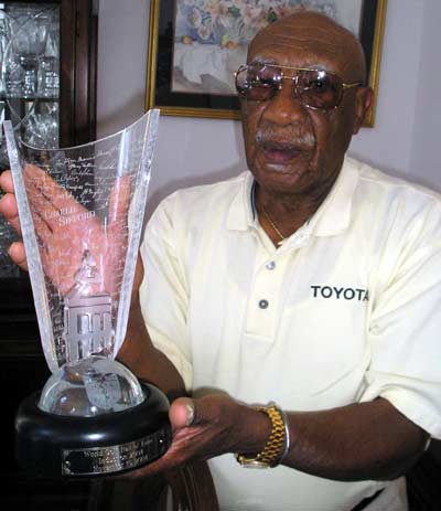 Charlie Sifford holding award