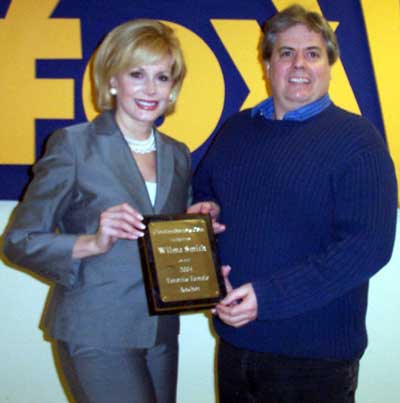 Wilma Smith receiving award as favorite female news anchor from Dan Hanson