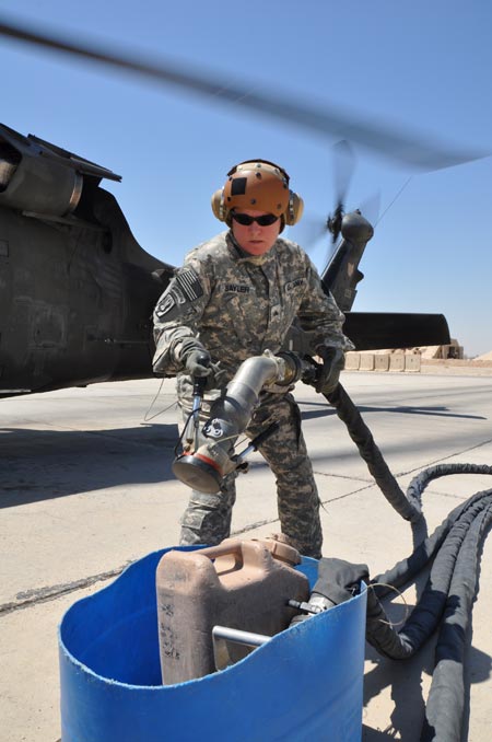 Oregon National Guard Sgt. Robin Sayler, Eugene, Ore., and an aircraft refueler attached to Company E, 1st Battalion, 137th Assault Helicopter Battalion of the Ohio National Guard, replaces a hose after refueling a UH-60 Black Hawk helicopter on Monday, August 24, 2009. U.S. Army photo by Staff Sgt. Jeff Lowry, Task Force 38 Public Affairs
