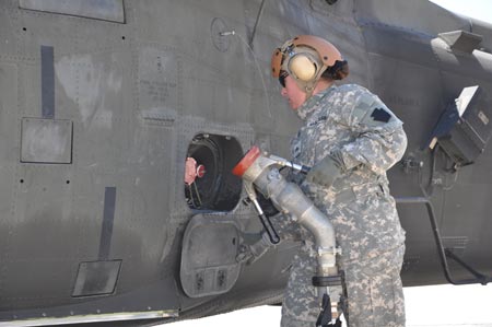Oregon National Guard Sgt. Robin Saylor, Eugene, Ore., and an aircraft refueler attached to Company E, 1st Battalion, 137th Assault Helicopter Battalion of the Ohio National Guard, finishes fueling a UH-60 Black Hawk helicopter on Monday, August 24, 2009. U.S. Army photo by Staff Sgt. Jeff Lowry, Task Force 38 Public Affairs