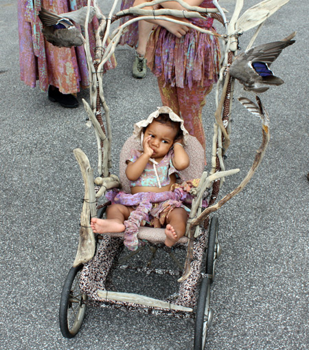 Baby in wood stroller