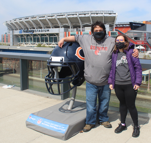 Fans posing with the Chicago Bears helmet