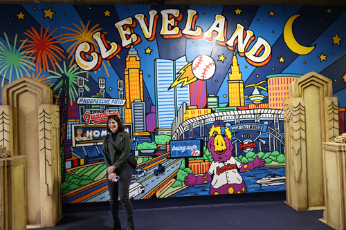 Artist in front of the mural