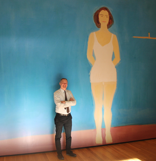 Curator Mark Cole in front of an image of The Bather