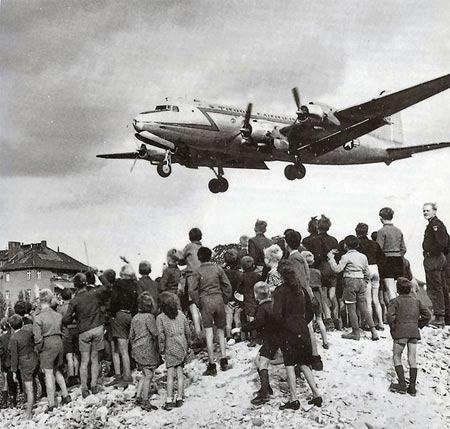 Berliners watching a C-54 land at Berlin Tempelhof Airport, 1948.