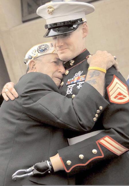 Old soldier hugs wounded young soldier