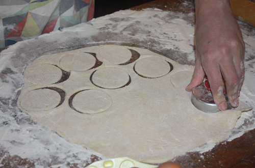 Cutting out dough for pierogis