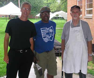 Father Chris helps cook burgers at Christ the King picnic
