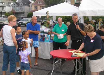Father Chris Weber announcing raffle winners at the St Philomena rib off
