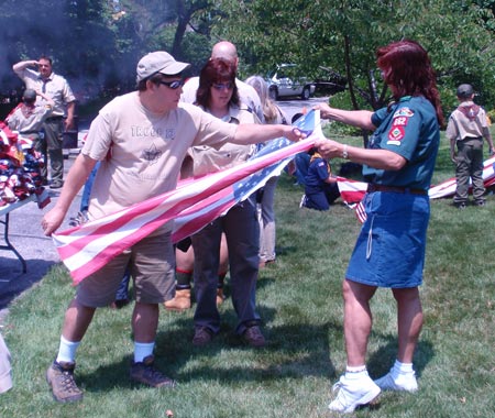Scouts cut the US flag for proper retirement