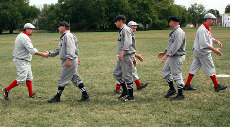 Cleveland Blues and Crossing Rails players shake hands after a game