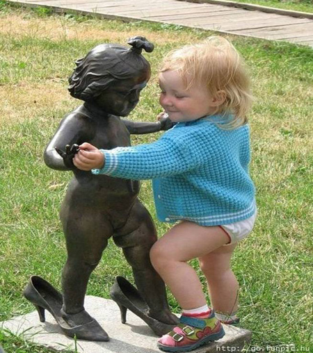 Baby dancing with statue