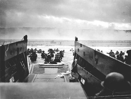 U.S. Army troops wade ashore on Omaha Beach during the landings, 6 June 1944