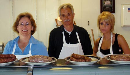 Old World Meats staff with different sausage types