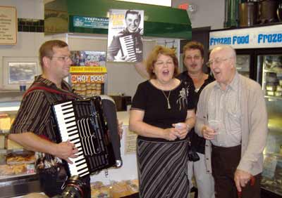 Accordionist Bob Kravos, Cecilia Dolgan, Bob Yankovic and some-time Yankovic vocalist Paul Yanchar lead a singalong at the reception at Raddell's Sausage Shop on Yankovic Square.