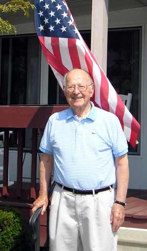 Bill Boehm in front of the flag he loves