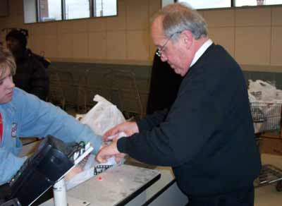 Burt Salzman working the checkout at Dave's on Payne Ave.