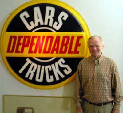 Del Spitzer with car dealership sign