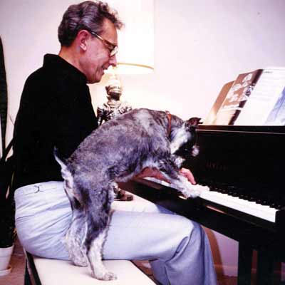 Howard Hoffmann duets with dog on piano