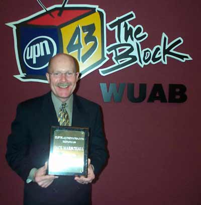 WUAB anchor Jack Marschall with is award