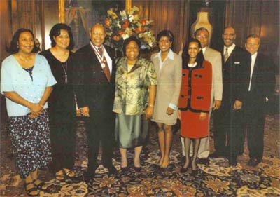 Louis Stokes receiving Congressional Distinguished Service Medal; from left, Shelley Hammond (daughter), Jay Stokes (wife), Alberta Johnson, The Honorable Lori Stokes (daughter), Roy Johnson, Chuck Stokes (son), and Brian Thompson 