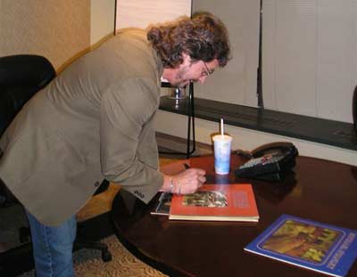 Michael Stanley signing his albums