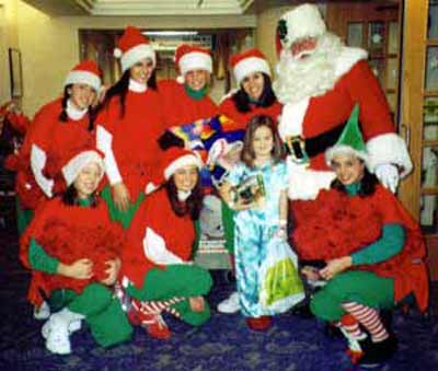 Santa Claus with Girl Elves and a sick child