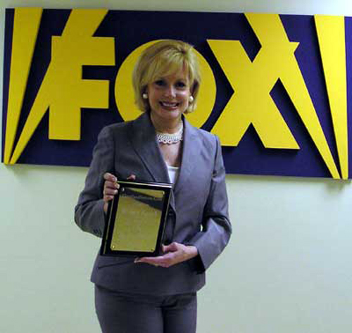 TV News Anchor Wilma Smith with her award